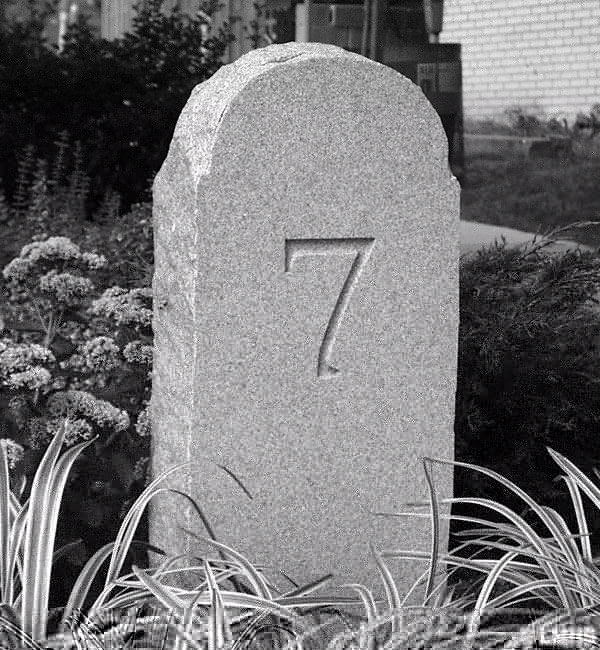 round-top stone carved with number 7