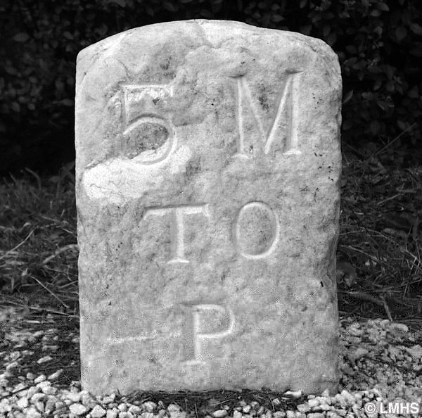 wide round-top stone carved with 5 M to P
