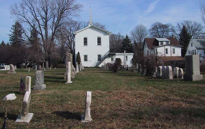 rows of stones with back of the church