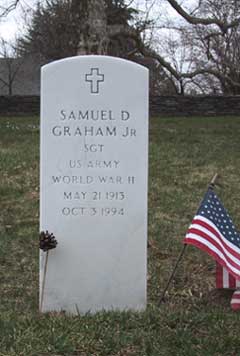 single white head stone: Samuel D. Graham, Jr., American flag at right