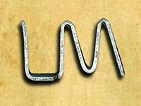 letters L, M connected, forged in silver metal