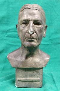 plaster bust of a man with light bronze patina