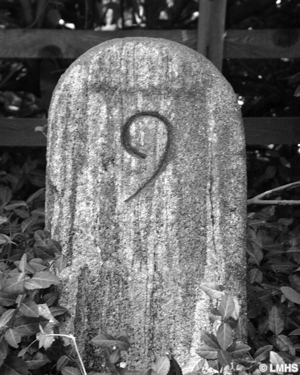 round-top stone carved with number 9