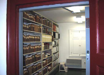 looking through doorway into room with built-in shelves full of books and boxes