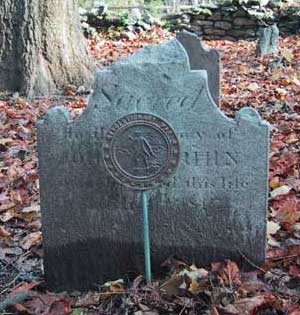 single gravestone with a Revolutionary war marker in front of it