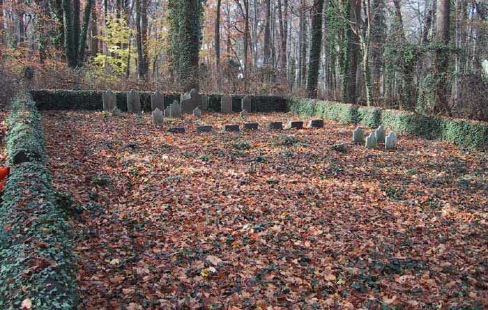 an ivy-covered wall encloseas the cemetery, headstones at far end