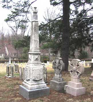 grave monuments: stone obelisk and two celtic crosses