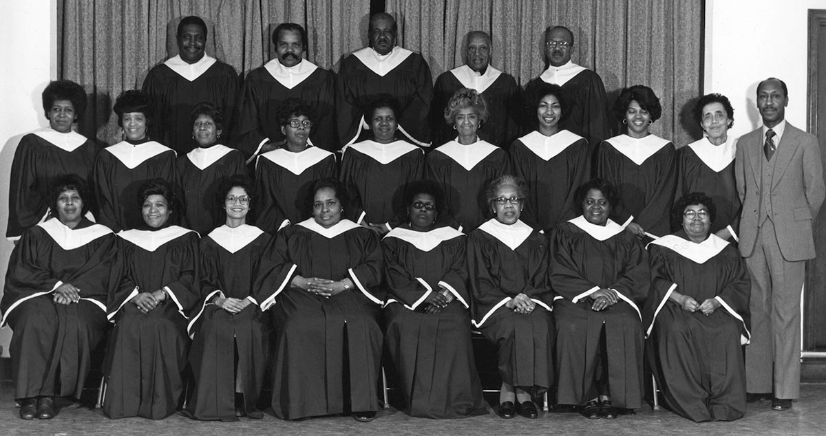23 African-American singers in choir gowns pose in three rows