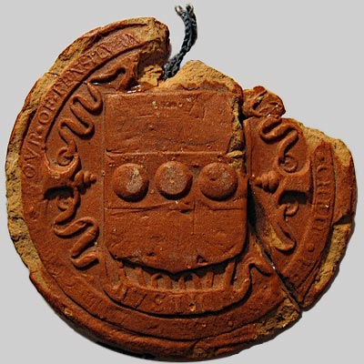 round, earthen red, embossed seal, string attached, piece missing at top right
